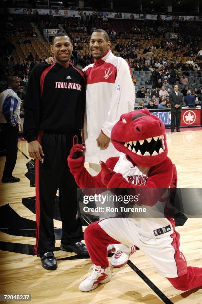 The Raptor poses with twin brothers Stephen Graham of the Portland Trail Blazers and Joey Graham of the Toronto Raptors before the NBA game at Air...