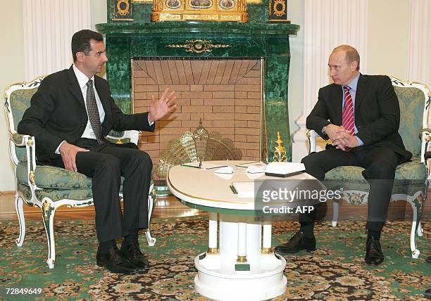 Moscow, RUSSIAN FEDERATION: Russia's President Vladimir Putin and Syrian President Bashar al-Assad talk as they meet in Moscow's Kremlin, 19 December...