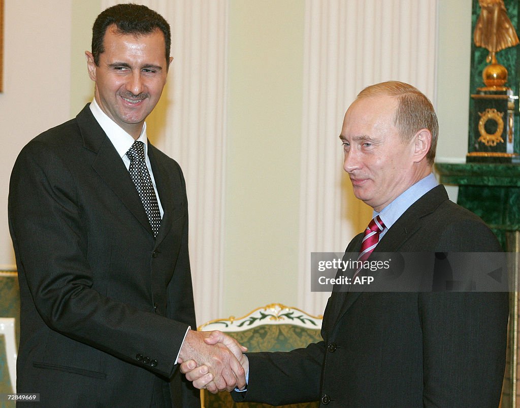 Russia's President Vladimir Putin (R) an