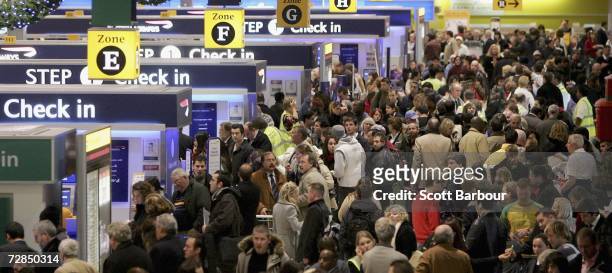Passengers queue to check-in at terminal 1 of Heathrow Airport on December 19, 2006 in London, England. Over the Christmas and New Year period...