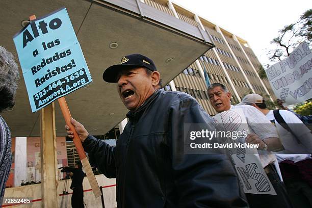 Latino man protests with activists the recent immigration raids across the country at a demonstration and news conference in front of the downtown...