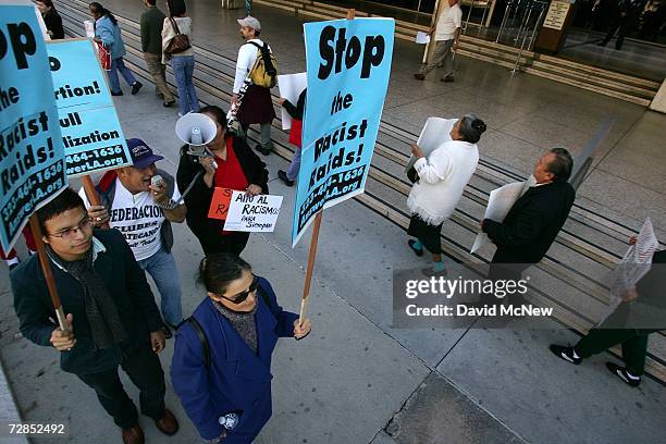 Latino activists protest recent immigration raids across the country at a demonstration and news conference in front of the downtown Federal Building...