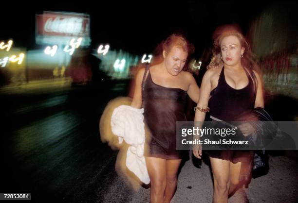 Gabbi and Erica walk near the coca cola factory on the Pan American road on February 1, 2002. In the last few years, an all-transvestite prostitution...