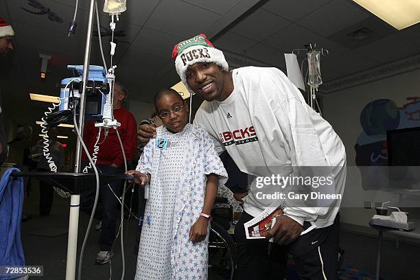 Michael Redd of the Milwaukee Bucks poses for a photograph with a patient on December 19, 2006 at Children's Hospital of Wisconsin in Wauwatosa,...