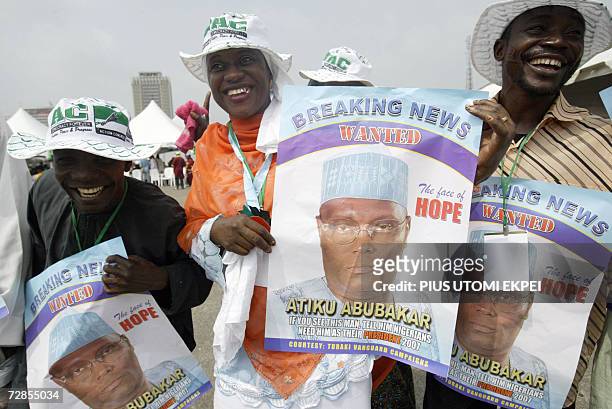 Supporters dance with posters of Nigerian Vice President Atiku Abubakar 20 December 2006 in Tafawa Balewa Square in Lagos, where the politician came...