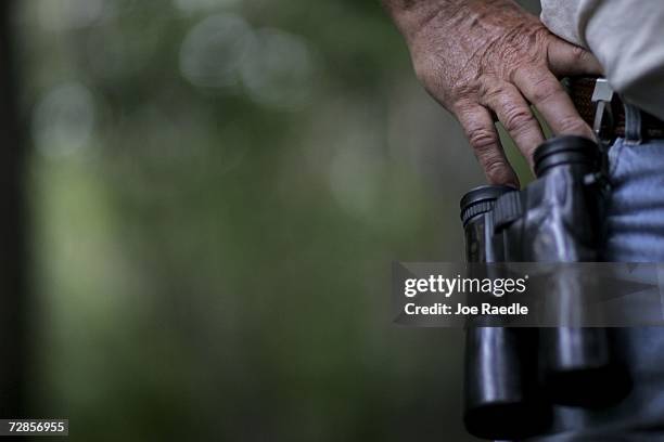 Bird counter Louie Toth clips his binoculars to a belt loop as he tries to spot birds during the Audubon Societies Christmas Bird Count December 20,...