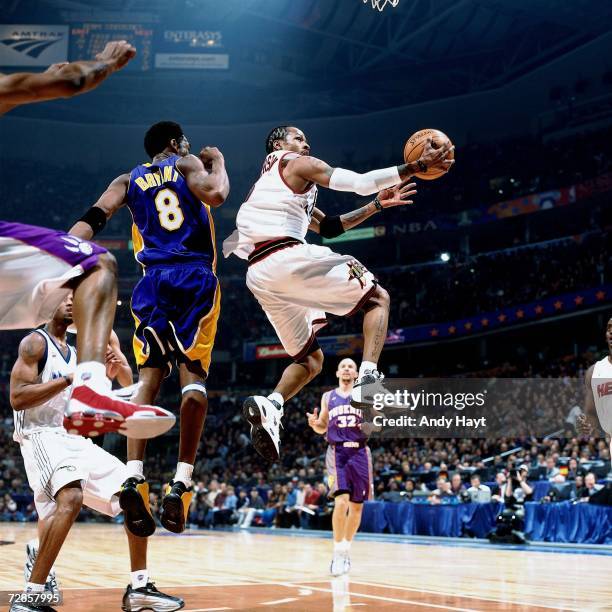 Allen Iverson of the Eastern Conference All-Stars attempts a layup against Kobe Bryant of the Western Conference All-Stars during the 2001 NBA...