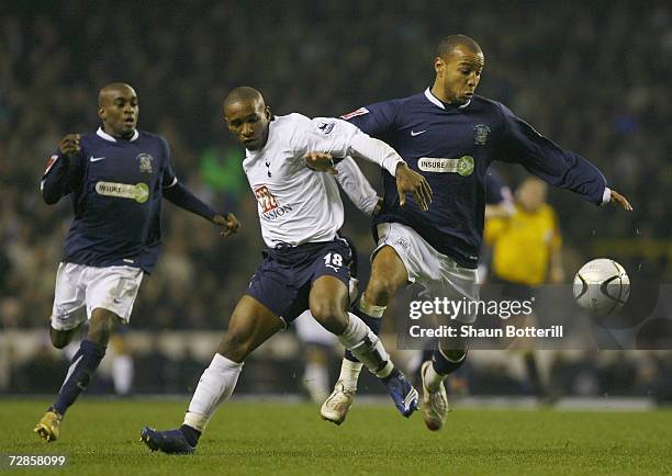 Jermain Defoe of Tottenham Hotspur tussles with Lewis Hunt of Southend United during the Carling Cup Quarter Final match between Tottenham Hotspur...