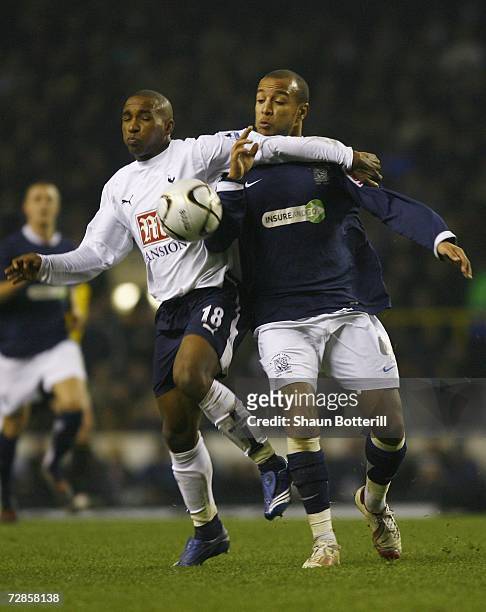Jermain Defoe of Tottenham Hotspur tussles with Lewis Hunt of Southend United during the Carling Cup Quarter Final match between Tottenham Hotspur...