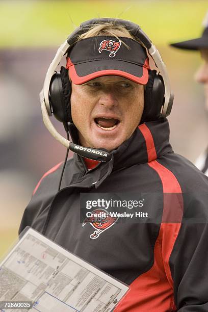 Head Coach Jon Gruden of the Tampa Bay Buccaneers talks with one of his assistant coaches during a game against the Chicago Bears at Soldier Field on...