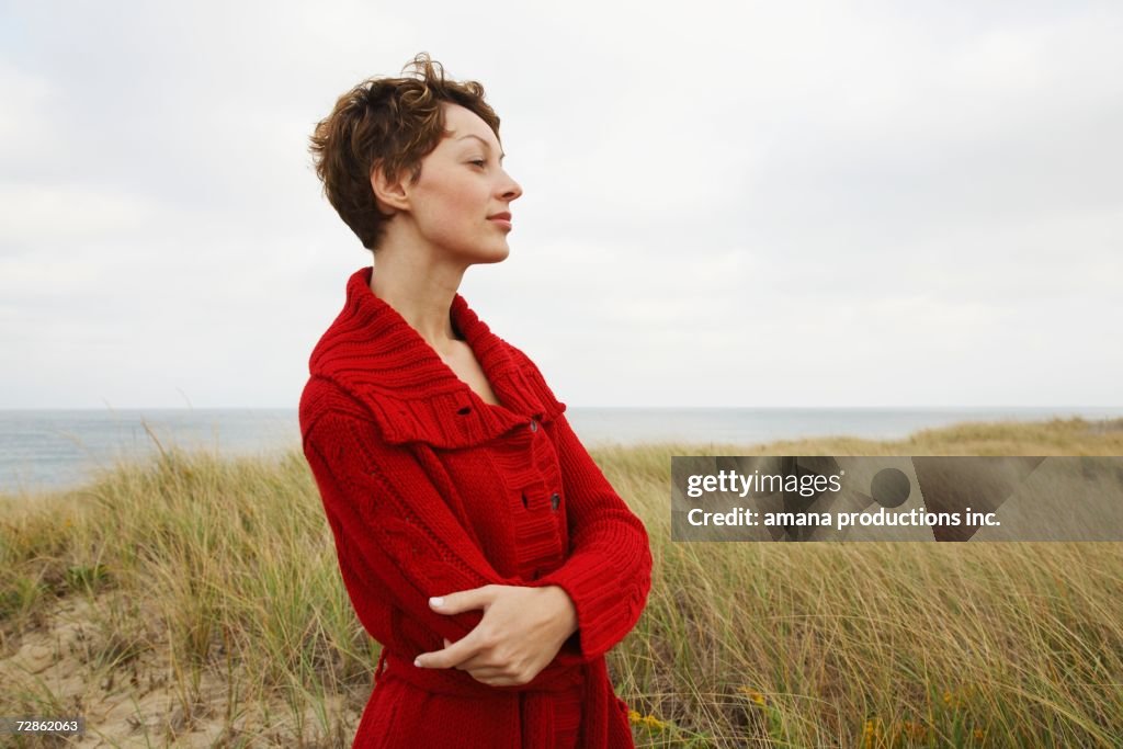 Woman in cardigan at beach