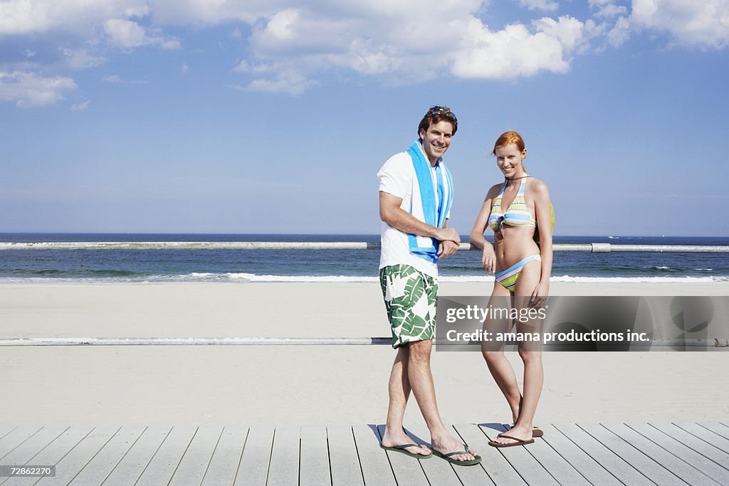 Young couple by railings at beach (portrait), Spring Lake, New Jersey, USA