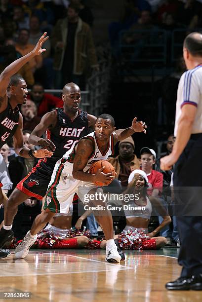 Maurice Williams of the Milwaukee Bucks guards posession of the ball against Gary Payton and James Posey of the Miami Heat on December 20, 2006 at...