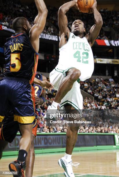 Tony Allen of the Boston Celtics goes hard to the basket against Baron Davis of the Golden State Warriors on December 20, 2006 at the TD Banknorth...