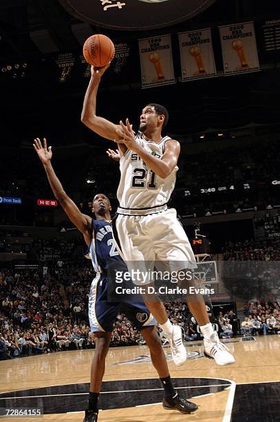 Tim Duncan of the San Antonio Spurs shoots against Hakim Warrick of the Memphis Grizzlies during the game at the AT&T Center on December 20, 2006 in...