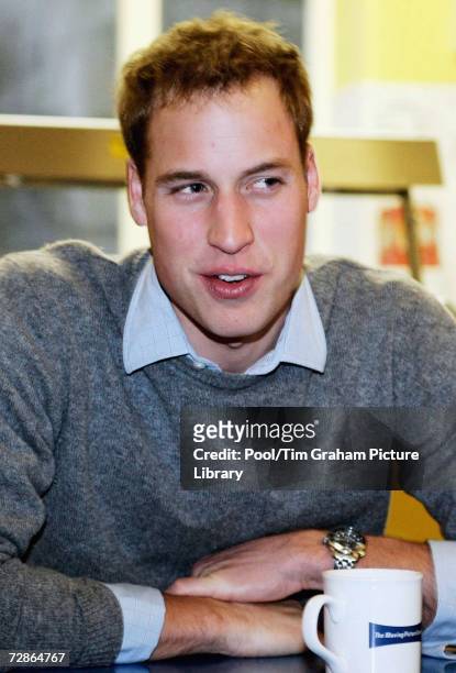Prince William with a mug of tea at a Centrepoint homeless hostel during his visit to the centre on December 20, 2006 in London, England.