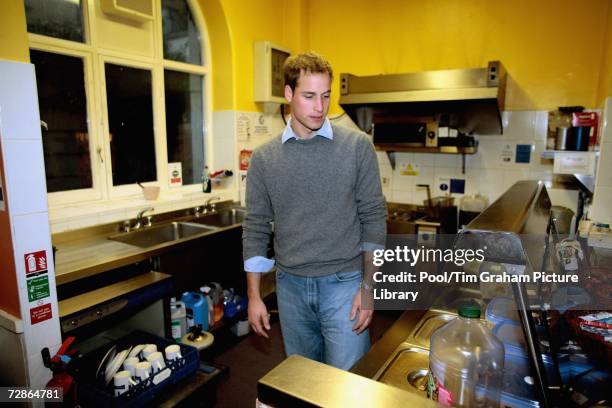 Prince William helps in the kitchen during a visit to a Centrepoint homeless hostel on December 20, 2006 in London, England.