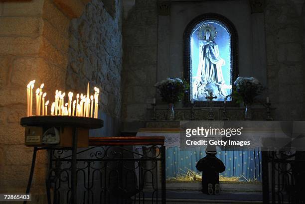 Palestinian child prays in the Fransciscan section of the Church of the Nativity, the traditional birthplace of Jesus, December 21, 2006 in the West...