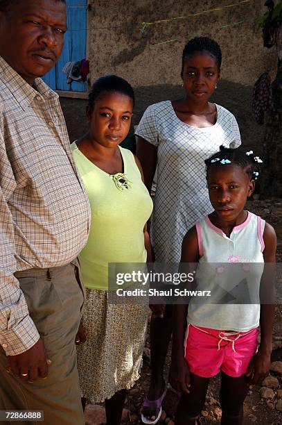 Tablita, a 14-year-old "restavek", poses with her "host" family, Ronald, his wife and their former "restavek" on March 30, 2005 in Port-au-Prince,...