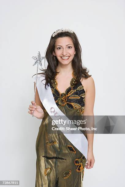 beauty queen wearing sash, holding magic wand, smiling - sash fotografías e imágenes de stock