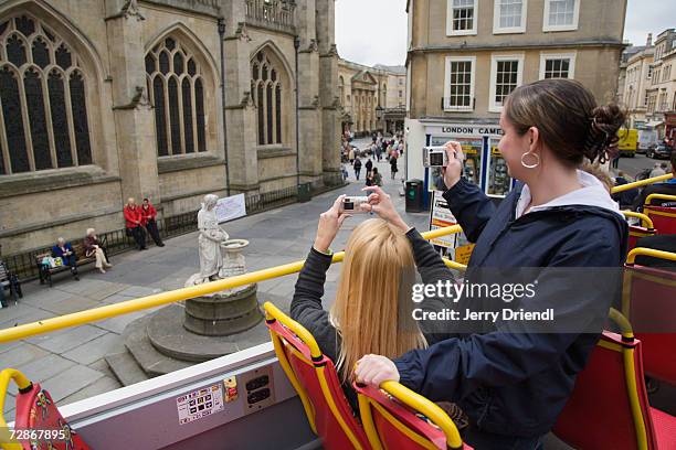 tourists taking photographs on open top bus - open top bus stock pictures, royalty-free photos & images