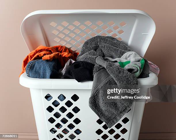 laundry basket filled with washing, close-up - washing basket stock pictures, royalty-free photos & images