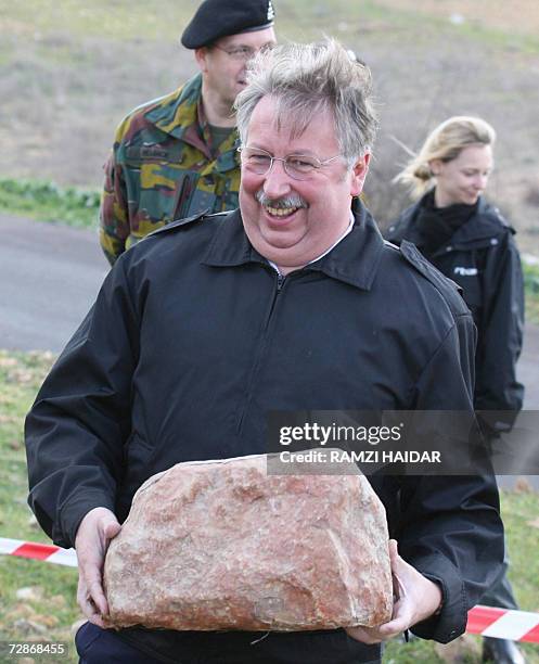 Belgian Defense Minister Andre Flahaut holds a landmine in the shape of a stone during his visit to the Belgian UNIFIL forces in the southern...