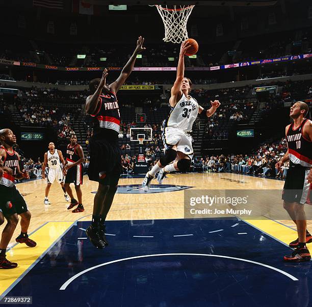 Mike Miller of the Memphis Grizzlies drives to the basket for a layup against Zach Randolph of the Portland Trail Blazers at the FedExForum on...