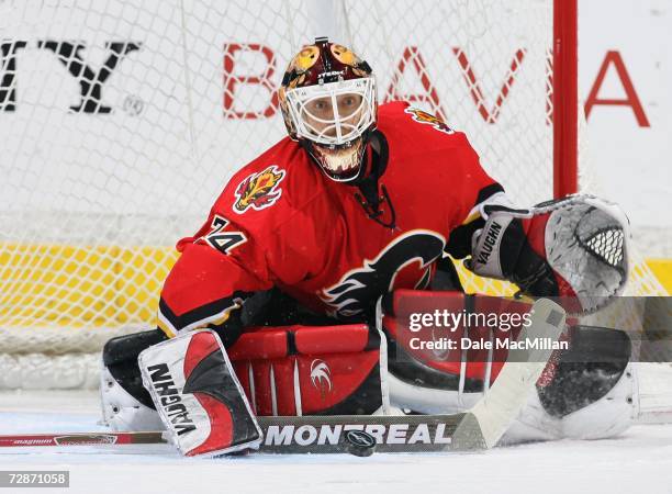 Miikka Kiprusoff of the Calgary Flames makes a save against the Minnesota Wild during their NHL game at Pengrowth Saddledome in Calgary, Alberta,...