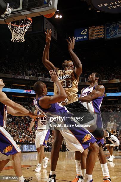 Brendan Haywood of the Washington Wizards takes out Leandro Barbosa of the Phoenix Suns on his way to the basket in an NBA game played on December 22...