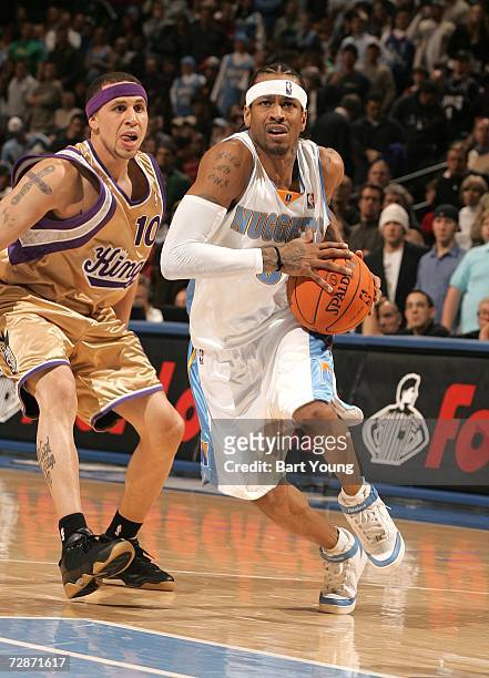 Allen Iverson of the Denver Nuggets goes to the basket against Mike Bibby of the Sacramento Kings at the Pepsi Center on December 22, 2006 in Denver,...