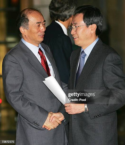 Japanese chief envoy Kenichiro Sasae chats with Chinese Vice Foreign Minister Wu Dawei at the closing of six-party talks on North Korea's nuclear...