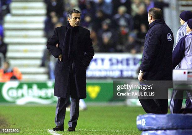 Wigan, UNITED KINGDOM: Chelsea manager Jose Mourinho looks back to the bench as Wigan Athletic manager Paul Jewell looks on during their English...