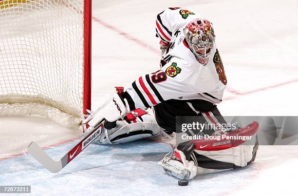 Goaltender Nikolai Khabibulin of the Chicago Blackhawks makes a kick save against the Colorado Avalanche on December 23, 2006 at the Pepsi Center in...