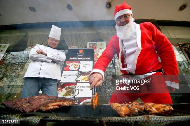 Man dressed as Santa Claus roasts beef on December 23, 2006 in Nanjing, Jiangsu Province, China. While Christmas Day is not a public holiday,...