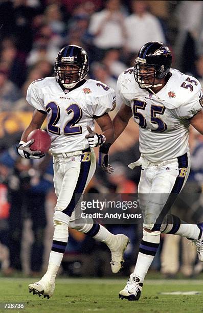 Duane Starks of the Baltimore Ravens celebrates with teammate Jamie Sharper after an interception touchdown during the Super Bowl XXXV Game against...