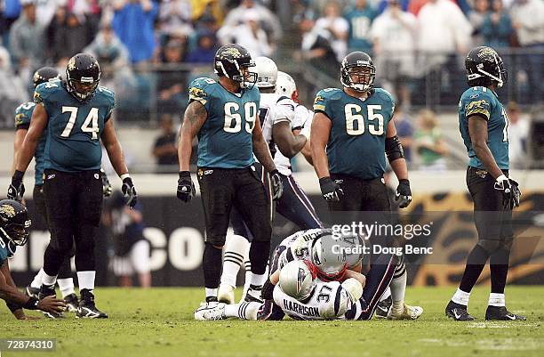 Linebacker Tedy Bruschi and Rodney Harrison of the New England Patriots celebrate a fumble recovery by Harrison as offensive lineman Maurice...