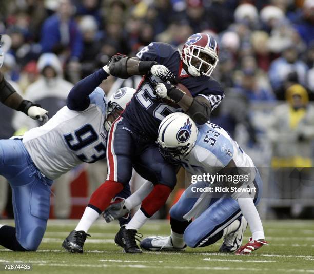 Anthony Thomas of the Buffalo Bills is tackled by Kyle Vanden Bosch and Keith Bulluck of the Tennessee Titans on December 24, 2006 at Ralph Wilson...