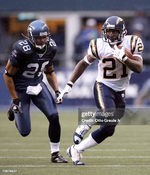 Runningback LaDainian Tomlinson of the San Diego Chargers rushes past safety Michael Boulware of the Seattle Seahawks on December 24, 2006 at Qwest...