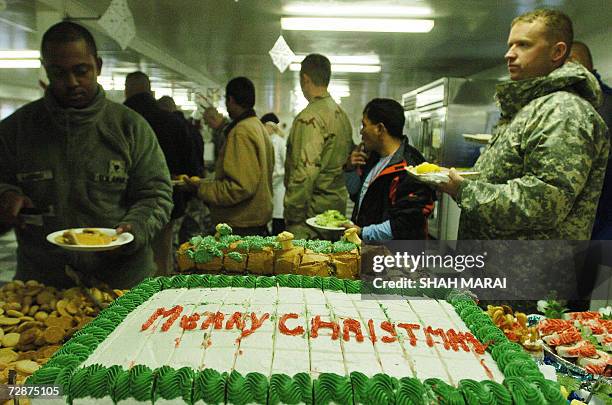 Soldiers line up for Christmas lunch at Bagram Air Base, some 50 kms north of Kabul, 25 December 2006. Many soldiers were able to call home on...