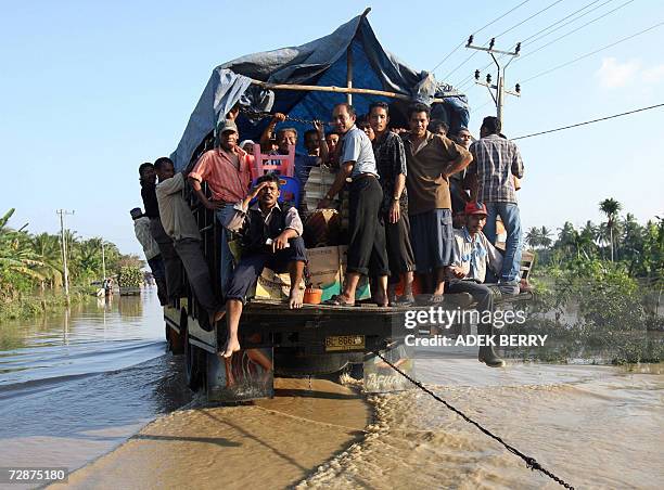 Truck full of passengers crosses flood water at Arakudo subdistrict in Langsa, East Aceh, 25 December 2006. Two years after the devastating tsunami,...