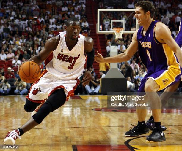 Guard Dwyane Wade of the Miami Heat drives against forward Luke Walton of the Los Angeles Lakers on December 25, 2006 at the American Airlines Arena...