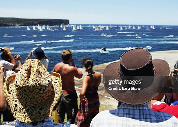 Crowd watches as boats sail past the North Head during the start of the 62nd Sydney to Hobart yacht race December 26, 2006 in Sydney, Australia. The...