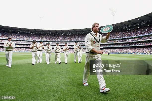 Shane Warne of Australia leaves the field after taking his 700th test wicket during day one of the fourth Ashes Test Match between Australia and...