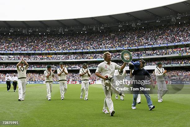 Shane Warne of Australia leaves the field after taking 5 wickets, including his 700th test wicket, during day one of the fourth Ashes Test Match...