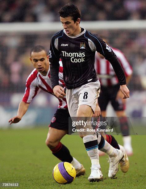 Joey Barton of Manchester City is challenged by Danny Webber of Sheffield United during the Barclays Premiership match between Sheffield United and...