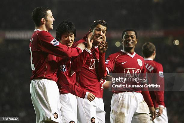 Cristiano Ronaldo of Manchester United is congratulated by team mates John O?Shea , Ji-sung Park and Patrice Evra after scoring his team's second...