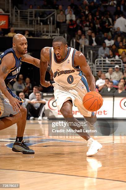 Gilbert Arenas of the Washington WIzards dribbles to the basket against Chucky Atkins of the Memphis Grizzlies on December 26, 2006 at the Verizon...