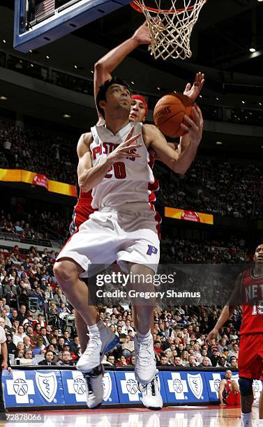 Carlos Delfino of the Detroit Pistons gets to the basket in front of Josh Boone of the New Jersey Nets at the Palace of Auburn Hills December 26,...