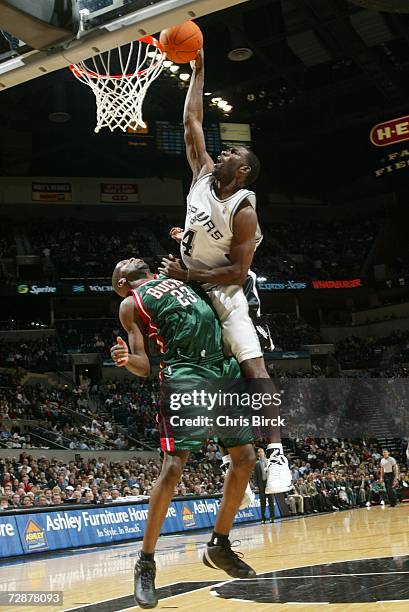 Michael Finley of the San Antonio Spurs dunks over Ruben Patterson of the Milwaukee Bucks at the AT&T Center December 26, 2006 in San Antonio, Texas....